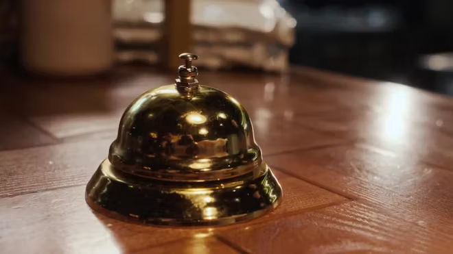 Brass service bell on a hotel front desk